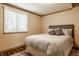 Relaxing bedroom featuring a window, hardwood floors, and soft lighting, creating a serene retreat at 8901 Shetland Ln, Indianapolis, IN 46278