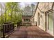 Exterior deck view showcasing wood flooring, railings, stone accents and surrounding trees at 8901 Shetland Ln, Indianapolis, IN 46278