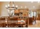 The dining area features a chandelier and opens up to a kitchen with wood cabinetry at 8901 Shetland Ln, Indianapolis, IN 46278