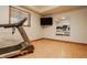 Home gym space with treadmill, TV, and mirror to facilitate fitness and exercise at 8901 Shetland Ln, Indianapolis, IN 46278