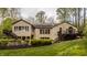 A beautiful home features stone and neutral siding, with well-manicured landscaping at 8901 Shetland Ln, Indianapolis, IN 46278