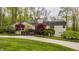 Elegant stone home with a large front yard, mature trees, and a beautiful deck perfect for outdoor relaxation at 8901 Shetland Ln, Indianapolis, IN 46278