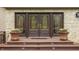 Inviting front entrance with decorative glass doors, potted flowers, and a warm, welcoming ambiance at 8901 Shetland Ln, Indianapolis, IN 46278