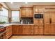 This kitchen showcases ample wood cabinets, granite countertops, and a built-in microwave oven at 8901 Shetland Ln, Indianapolis, IN 46278