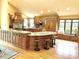 Spacious kitchen with wood cabinets, a large island, granite counters and a window seat at 8901 Shetland Ln, Indianapolis, IN 46278