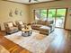 Cozy living room with hardwood floors, comfortable seating, and sliding glass doors to outdoor patio at 8901 Shetland Ln, Indianapolis, IN 46278