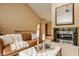 Inviting living room with a fireplace, comfortable leather sofa, and vaulted ceilings at 8901 Shetland Ln, Indianapolis, IN 46278