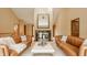 Spacious living room with vaulted ceiling, featuring leather sofas, a fireplace, and plenty of natural light at 8901 Shetland Ln, Indianapolis, IN 46278