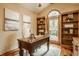 Home office featuring built-in bookshelves, stylish desk, and great views of the yard at 8901 Shetland Ln, Indianapolis, IN 46278