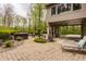 Paved patio featuring outdoor seating, landscaping, and stairs to the backyard at 8901 Shetland Ln, Indianapolis, IN 46278