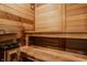 Wooden sauna interior with bench seating and heater for a relaxing spa experience at 8901 Shetland Ln, Indianapolis, IN 46278