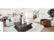 Open-concept living area features a staircase, modern decor, and seamless flow into the adjacent kitchen at 9149 Rockville Pl, McCordsville, IN 46055