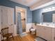 Bathroom showcasing a walk-in shower with subway tile, a wooden vanity and blue-painted walls at 9243 Compton Farm Ln, Indianapolis, IN 46259