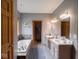 A view of a bathroom featuring a tub, dual sinks, wood-trimmed windows and doors at 9243 Compton Farm Ln, Indianapolis, IN 46259