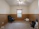 A beige and brown bedroom with ceiling fan, window, and black office chair at 9243 Compton Farm Ln, Indianapolis, IN 46259