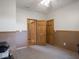 A bedroom painted two-tone tan with neutral carpeting and wood-panel doors at 9243 Compton Farm Ln, Indianapolis, IN 46259