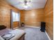 Comfortable bedroom with wood paneled walls, carpet, and ceiling fan at 9243 Compton Farm Ln, Indianapolis, IN 46259