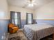 Comfortable bedroom features a ceiling fan and chair at 9243 Compton Farm Ln, Indianapolis, IN 46259