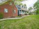 Charming home showcasing a blend of brick and siding, complemented by a well-manicured lawn and inviting walkway at 9243 Compton Farm Ln, Indianapolis, IN 46259