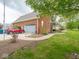 Home featuring a brick exterior and a spacious driveway leading to an attached garage with sidewalk to front porch at 9243 Compton Farm Ln, Indianapolis, IN 46259