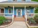 Inviting front porch featuring a stylish entryway, complemented by well-maintained landscaping for added curb appeal at 9243 Compton Farm Ln, Indianapolis, IN 46259