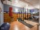 A well-equipped home gym with weightlifting equipment, a heavy punching bag and a TV for entertainment at 9243 Compton Farm Ln, Indianapolis, IN 46259