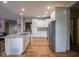 Spacious kitchen showcasing the island with granite counters, stainless steel appliances, and wood floors at 9243 Compton Farm Ln, Indianapolis, IN 46259