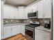 Kitchen featuring stainless steel oven, microwave, and mosaic backsplash at 9243 Compton Farm Ln, Indianapolis, IN 46259