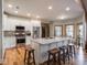 Modern kitchen featuring stainless steel appliances, white cabinetry, and a large island at 9243 Compton Farm Ln, Indianapolis, IN 46259