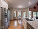 Open floor plan kitchen with a large island with granite countertops at 9243 Compton Farm Ln, Indianapolis, IN 46259