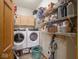 Laundry room with modern washer, dryer, white wire shelves, and an adjacent oak door at 9243 Compton Farm Ln, Indianapolis, IN 46259