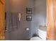 A light and clean powder room with framed artwork, toilet, and a towel rack at 9243 Compton Farm Ln, Indianapolis, IN 46259