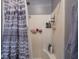 A shower is shown with a sliding curtain, installed shelf, and shower supplies at 9243 Compton Farm Ln, Indianapolis, IN 46259
