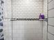 Close-up of the tiled walk-in shower with a shower curtain and built in shelving for toiletries at 9243 Compton Farm Ln, Indianapolis, IN 46259