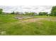 This large yard features garden beds, a lawn, and mature trees, providing an open and inviting feel at 9243 Compton Farm Ln, Indianapolis, IN 46259
