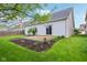 View of the home's backyard showing the patio, landscaping, and sliding glass door access to the interior at 963 Kempson Ct, Westfield, IN 46074
