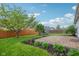 Home's backyard featuring a beautiful, well-maintained lawn and landscaping, mature trees and brick paver patio at 963 Kempson Ct, Westfield, IN 46074