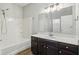 Bathroom with tub and shower combination and dark wood cabinets below a large mirror at 963 Kempson Ct, Westfield, IN 46074