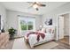 Bright bedroom features a ceiling fan, large window with natural light, and an inviting bed at 963 Kempson Ct, Westfield, IN 46074