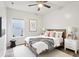 Bright bedroom featuring a ceiling fan, light wood bed frame, and ample natural light from the window at 963 Kempson Ct, Westfield, IN 46074