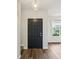 Hallway featuring hardwood floors, a statement light fixture, and a clear view to the outside at 963 Kempson Ct, Westfield, IN 46074