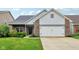 Charming home featuring a two-car garage, brick accents, and a well-manicured lawn at 963 Kempson Ct, Westfield, IN 46074