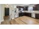 Spacious kitchen equipped with stainless steel appliances, dark wood cabinetry, and hardwood flooring at 963 Kempson Ct, Westfield, IN 46074