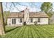 Rear view of a house featuring a well-manicured lawn, patio, and tidy landscaping at 9688 Amber Glow Ct, Fishers, IN 46037