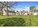 Large backyard featuring lush lawn and mature trees offering a serene outdoor space at 9688 Amber Glow Ct, Fishers, IN 46037