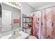 Bathroom featuring a vanity, mirror, shelving unit, and shower with patterned curtain at 9688 Amber Glow Ct, Fishers, IN 46037
