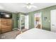 Bright bedroom with green walls featuring an en suite bathroom and walk-in closet at 9688 Amber Glow Ct, Fishers, IN 46037