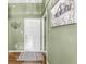 Entryway with hardwood floors, olive green walls, and a door, showcasing the home's decor at 9688 Amber Glow Ct, Fishers, IN 46037