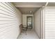 Cozy porch with neutral siding and a metal bench near the front door at 9688 Amber Glow Ct, Fishers, IN 46037