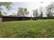 Large backyard featuring a brick home, in-ground pool, hot tub, and lush green space at 1000 Riverview Dr, Martinsville, IN 46151